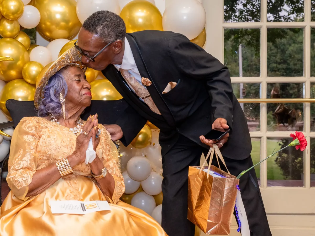 Joseph Hunt kisses his mother, Ernestine, during her 90th birthday party.